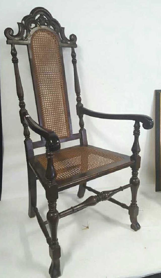Antique Spanish Renaissance Mahogany Armchair: Antique Spanish Renaissance Mahogany Armchair. Open carved florette crown with scroll ears. Caned seat back and seat. Scrolled arms. Turned stiles. Walnut period legs and feet, carved stretchers. Meas