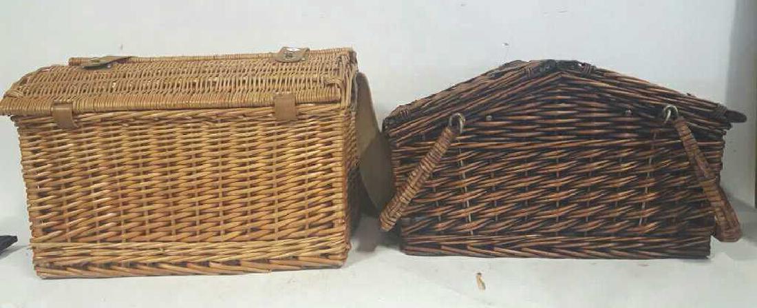 Two Fully Furnished Wicker Picnic Baskets: Two Fully Furnished Wicker Picnic Baskets. Leather and brass fittings to hold cups, wine glasses, and plates. Partially upholstered insides. The first basket comes with a carrying case for utensils. L