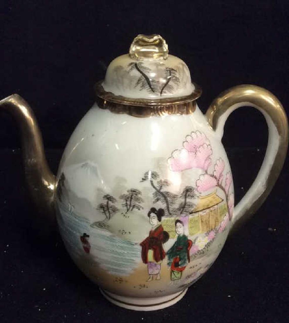 Hand Painted Nippon Lidded Tea Pot Hand painted with: Hand painted with Asian Figures and gardens, gold trimmed with lid. Marked hand painted Nippon. Measures ht app 8 inches. Property of Former New York City Antique Store