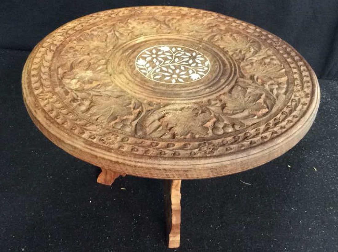 Carved Far East Wood and Bone Low Table Carved low: Carved low table stand or centerpiece Pedestal circular surface removable folding three legged base. Measures diameter 11,5 inches, ht 7.5 inches, carved center bone design floral motif. Property of f