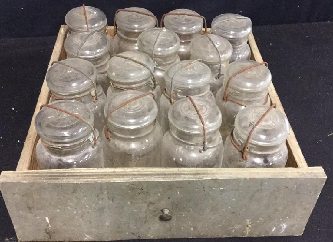 Group Lot Of Vintage Canning Mason Jars: Assortment of 15 clear glass canning mason jars with metal bail. Jars marked Ball Ideal and Atlas E-Z Seal. Jars need to be cleaned, rust on bails. Jars measure 7.5 in he's H x 3.5 inches diameter.