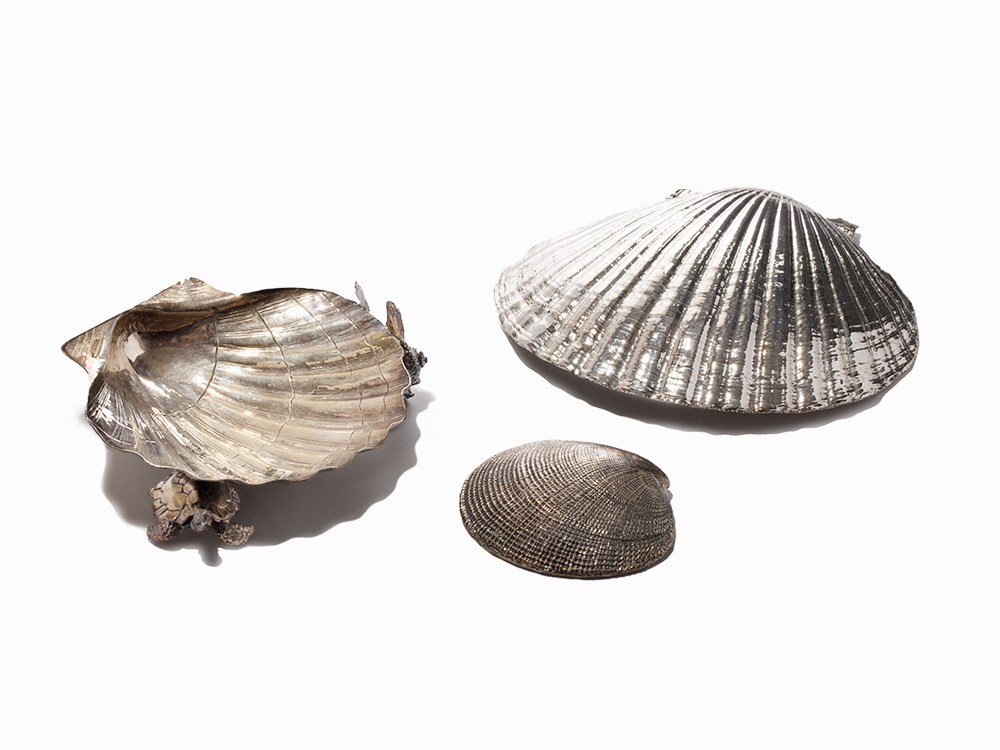 Mario Buccellati, 3 Silver Shells: Scallop shells and silver Milan, Italy, 20th C. Mario Bucellati of Buccellati Holding Italia – Italian luxury jewelry and watch makers, active since 1919 Each shell features a metal crest with ‘Ma