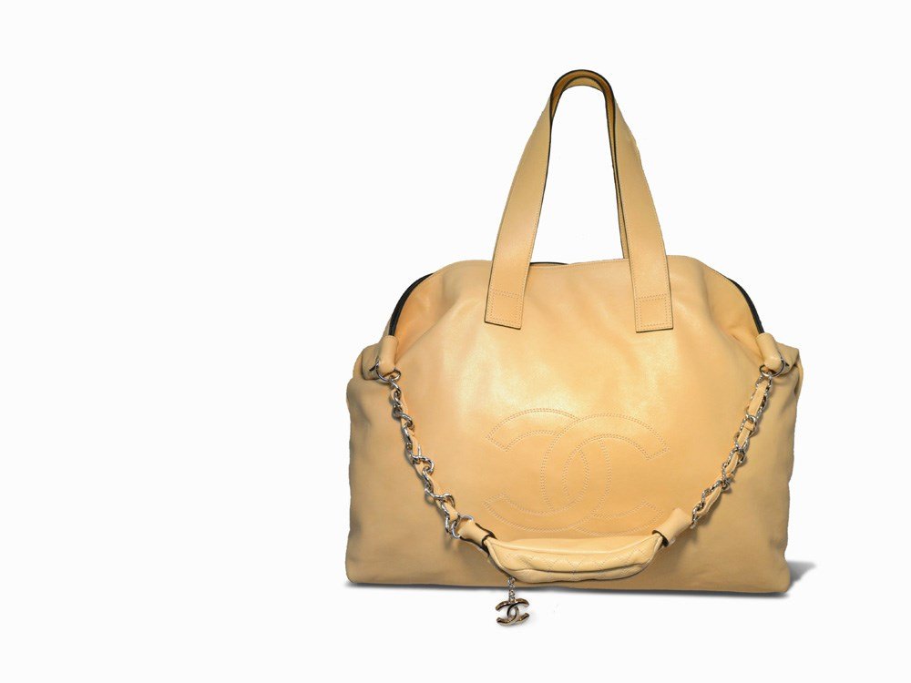 Chanel, Beige Lambskin Weekend Shoulder Bag Tote: Soft beige lambskin leather Chanel, France Silver hardware and CC logo stitched along the front side Double leather handle straps; woven leather and chain shoulder Slate grey satin lined interior that