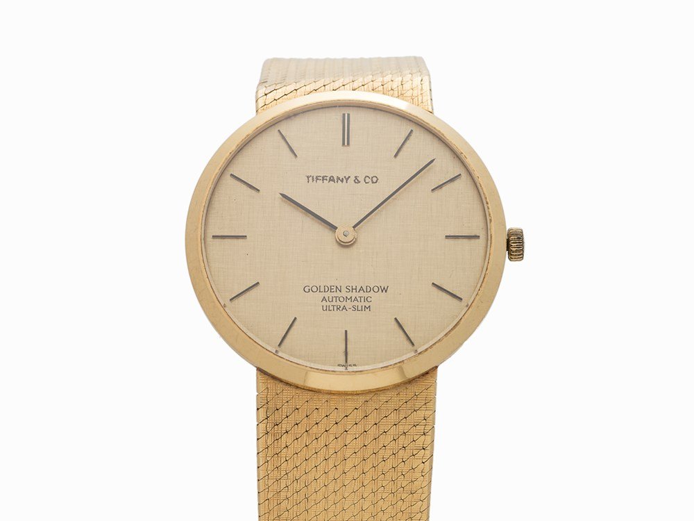 Universal Geneve Golden Shadow Retailed by Tiffany &: Universal Geneve Golden Shadow Retailed by Tiffany & Co. Switzerland, circa 1965 Automatic movement, caliber 2-66, 25 jewels; hours, minutes Gold textured dial with applied black Baton hour-markers; B