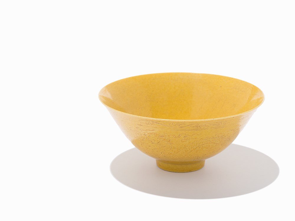 Dragon Bowl with Egg-Yolk Glaze, Xianfeng mark and: Porcelain with egg-yolk glaze China, Xianfeng period (1851-1861) Fine thin walled bowl on a high foot, surrounded by a ruyi band Exterior wall is lavishly embellished with a delicately incised pair of