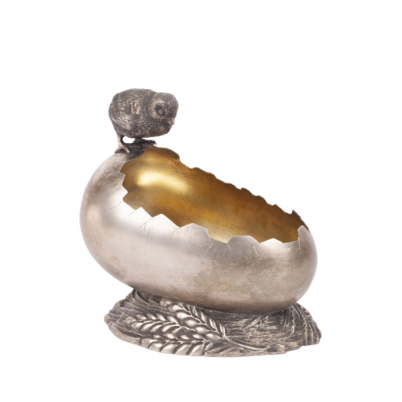 A Russian silver candy bowl in the shape of broken egg by Grachev Brothers: An Unusual Russian silver candy bowl in the shape of broken egg with cast silver figure of a chick on the top. Marked Grachev Brothers in cyrillic with Imperial warrant. Petersburg, 1899-1908. Dimensi