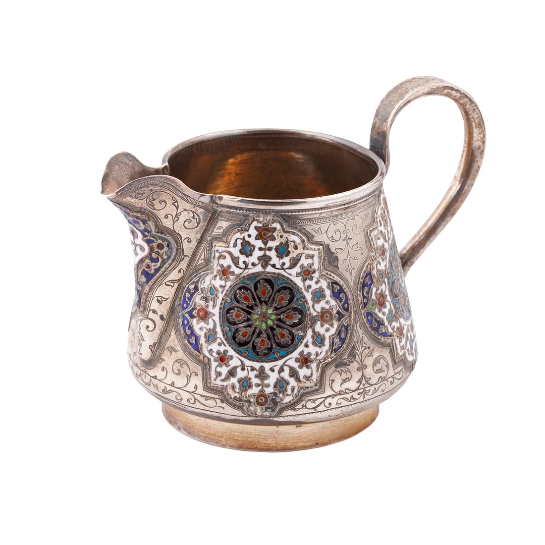 A Russian silver-gilt and champleve enamel milk jug: A Russian silver-gilt and champleve enamel milk jug. Makers mark of I. Shetinin. Moscow, 1894. Dimensions: 9 x 12,5 x 9 cm. Weight: 183 g.