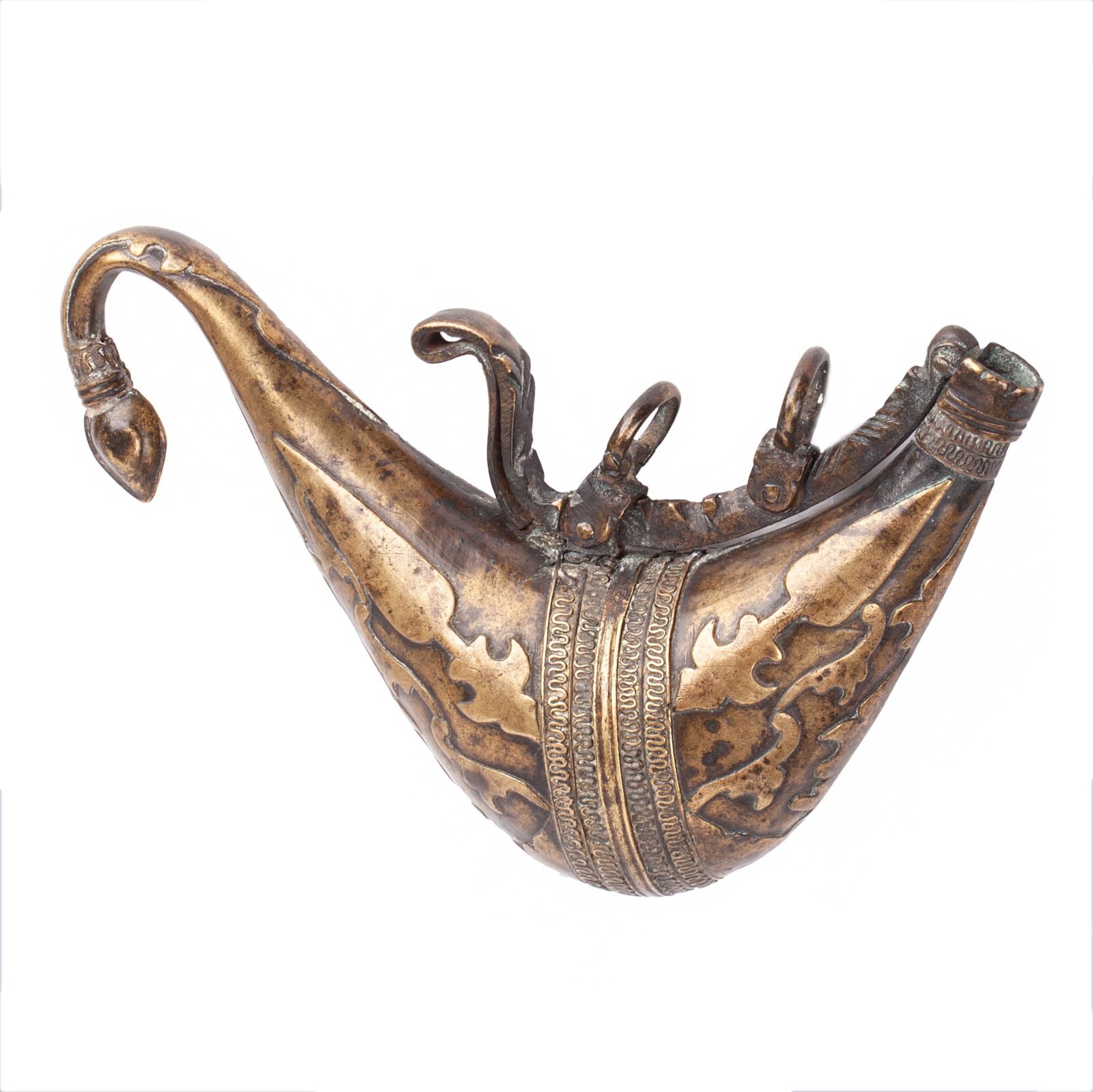 A 19th c. Persian antique Islamic brass powder flask: A 19th c. Persian antique Islamic brass powder flaskA Persian powder flask of characteristic shape, made of brass and decorated with intricate floral motifs.Dimensions: 18.8 x 16 x 5 cm.