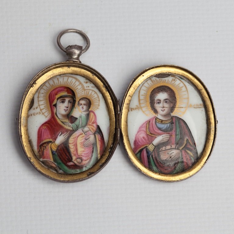 Medallion, Moscow, before 1898.: Locket (medallion) with the images of Saint Martyr Panteleimon and Mother of God of Iverskaya. Enamel, silver, engraving. Makers mark AC. Moscow, before 1898. 3,7*3,2*6 cm.