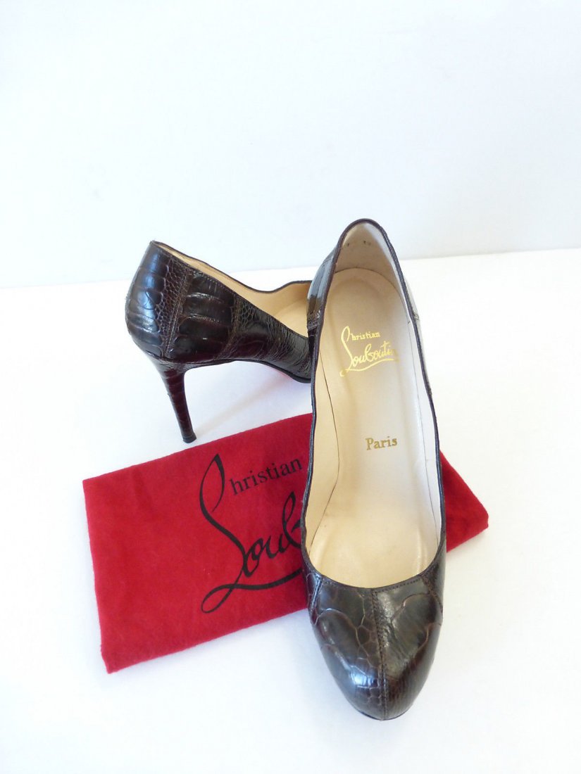 Christian Louboutin Genuine Crocodile Pumps: Size 8.5/39 crocodile Christian Louboutin brown pumps with decorative stitching detail. Made in Italy. Retailed for $4,645.00. 4.25" heel. Insole measuring 10.25". Comes with original CL duster bag.