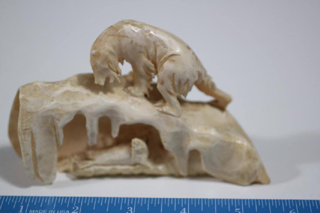 5"L x 3 1/8"H Eskimo Carving out of Walrus depicting a (1 of 2)