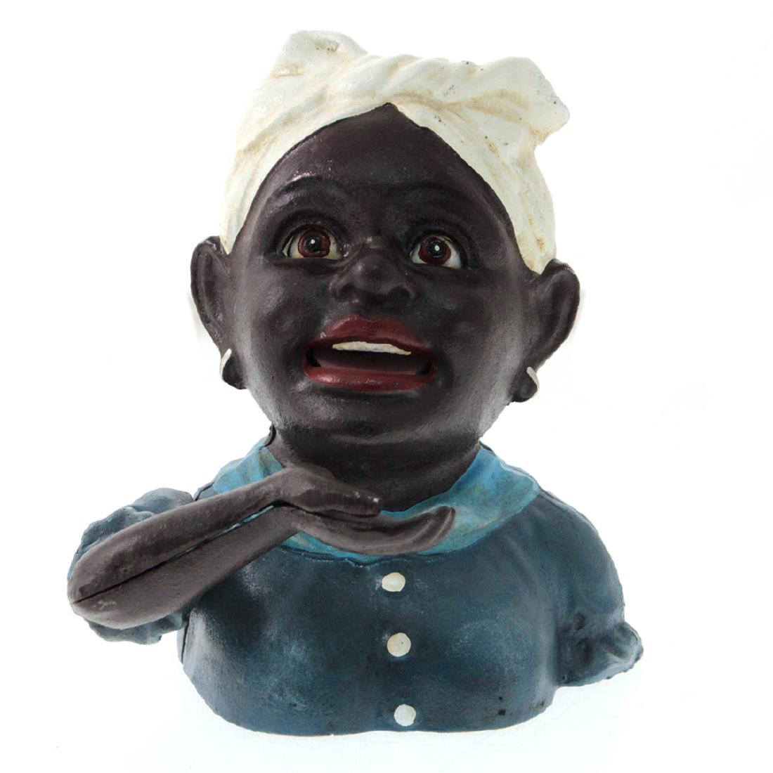 Afro-American Woman Cast Iron Mechanical Bank.: Afro-American Woman Cast Iron Mechanical Bank. Working condition. Base inscribed - John Harper Pat 631. 17cm.