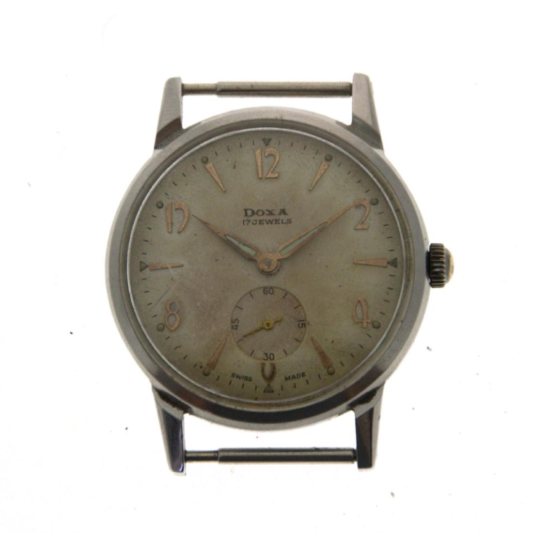 Doxa Wrist Watch.: Doxa Wrist Watch. Stainless steel. Mechanical movement. Separate seconds dial. Working condition. 34mm. Crack to the plastic cover.