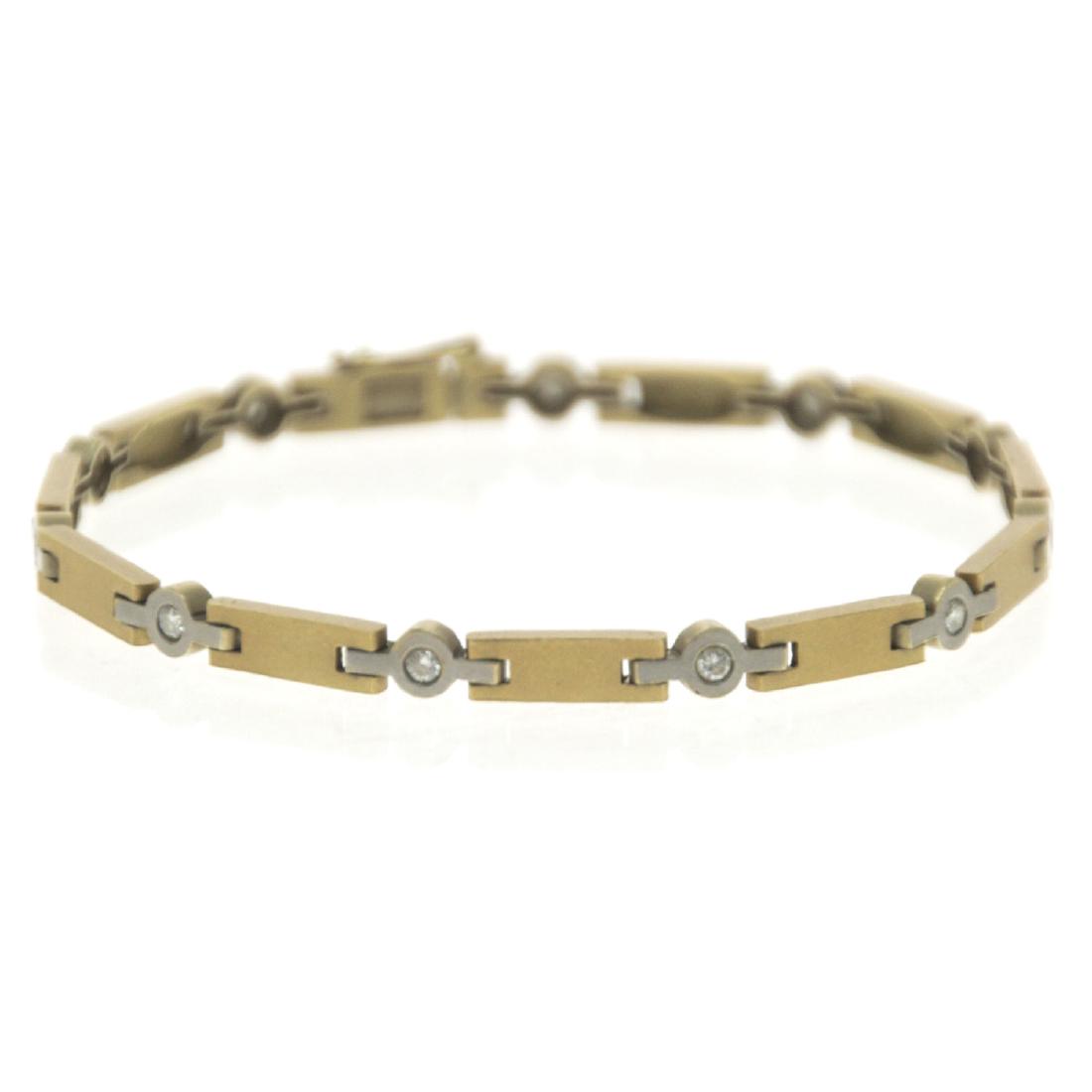 18k White and Yellow Gold Diamond Bracelet.: 18k White and Yellow Gold Diamond Bracelet. 11 diamonds in total weight of about 0.44ct. Safety clasp. Marked. Length: 19cm. 14.78gr.