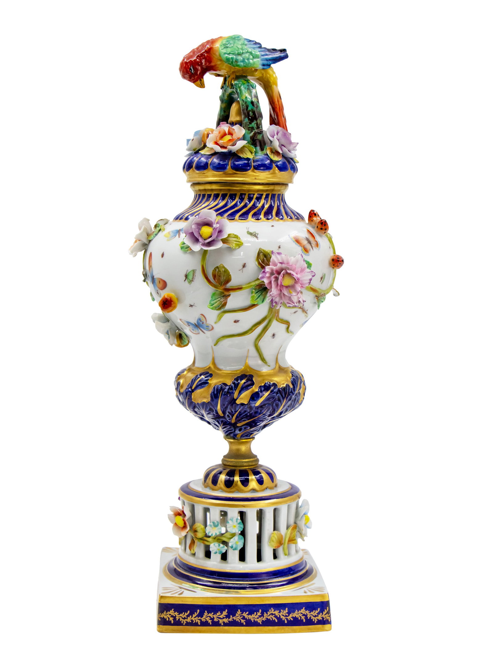Sevres Style Porcelain Urn.: Sevres Style Porcelain Urn. Painted rural family scene surrounded by flowers, leaves, butterflies and insects. Parrot figure to the top of the urn. Marked. Height: 43cm. Minor flaws.