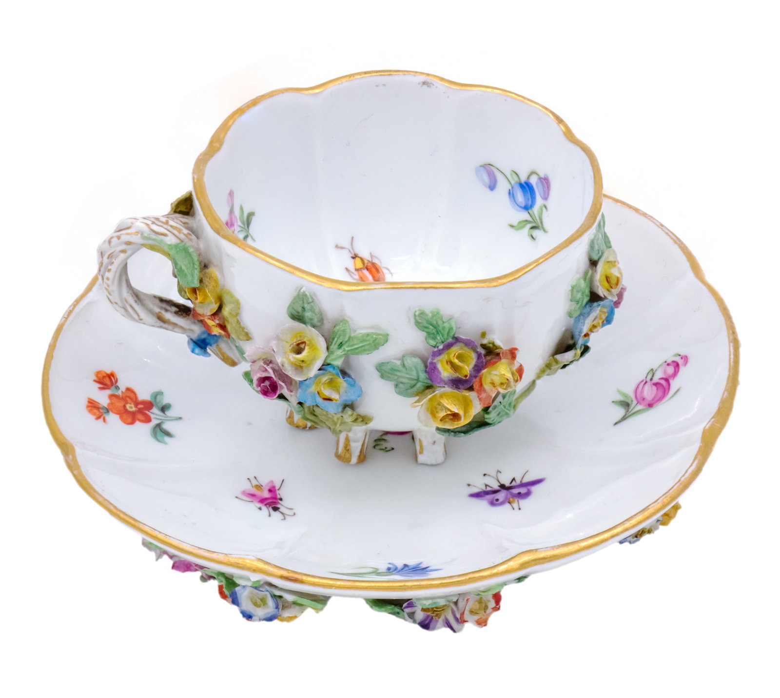 Meissen Porcelain Demitasse Cup and Saucer, Germany, Circa 1880.: Meissen Porcelain Demitasse Cup and Saucer, Germany, Circa 1880. Six Footed Cup and Saucer. Tiny clusters of flowers are hand applied around the outside of the cup and bottom of the saucer. The handle