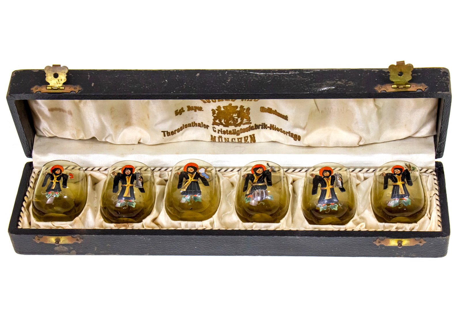 Eduard Rau Set of Six Glass and Enamel Liqueur Tots, Munich, Germany, Late 19th Century.: Eduard Rau Set of Six Glass and Enamel Liqueur Tumbler Tots Cups, Munich, Germany, Late 19th Century. Smoky glass, each with an enamel painting of the Munchner Kindl. Original box. Tot height: 4cm.