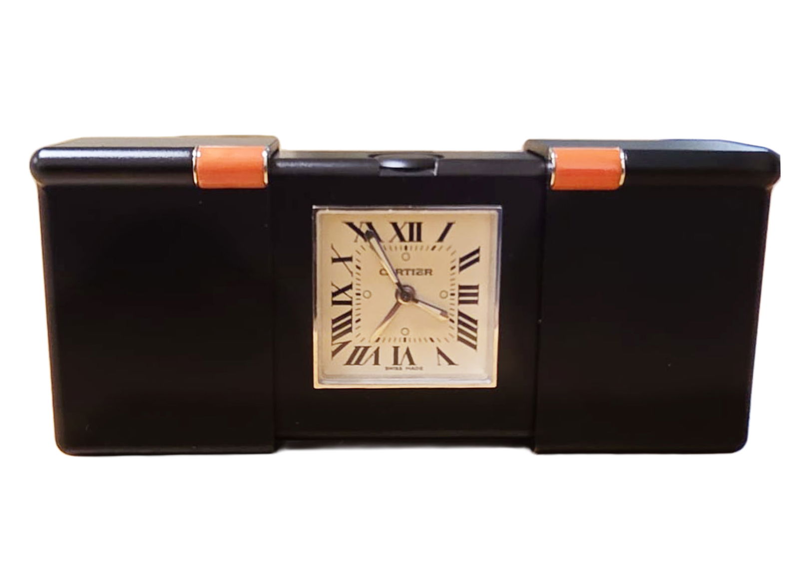 Cartier Turn on The Century Travel Alarm Clock.: Cartier Turn on The Century Travel Alarm Clock. Quartz movement, NOT in a working condition. Teflon case, two corals. Original box and papers. Ref: 2705 5.7x4x1.8cm.