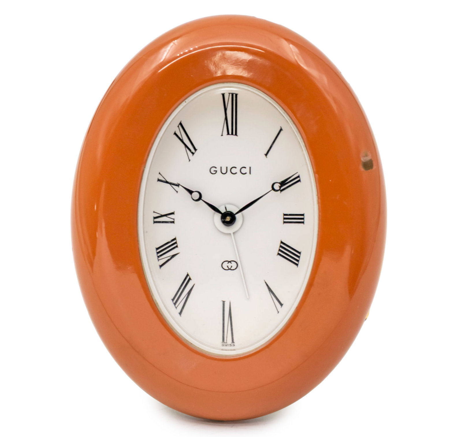 Gucci Table Alarm Clock.: Gucci Table Alarm Clock. Mechanical movement, eight days, working condition. Alarm movement, working condition. Peach enamel Oval frame, flaws. Height: 10cm.