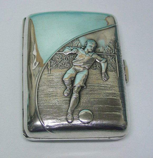 Sterling Silver Soccer Cigarette Case, England, 1916.: Sterling Silver Soccer Cigarette Case, England, 1916. By Henry Matthews, Birmingham, England, 1916. Of rectangular curved form, embossed with a football scene. Gilt interior. Fully hallmarked for Birm