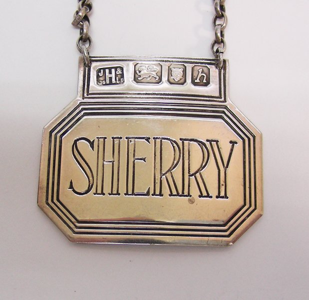 Sterling Silver Sherry Wine Label John Harvey & Sons: Sterling Silver Sherry Wine Label By John Harvey & Sons, London, England, 1963. Of canted rectangular form, engraved Sherry. Fully hallmarked for London, England, dated 1963, maker's mark for John Har