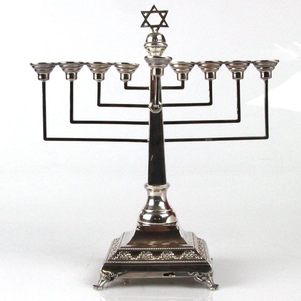 Sterling Silver Musical Hanukkah Menorah A. Taitelbaum: Sterling Silver Musical Hanukkah Menorah, Aaron Taitelbaum, London, England, 1949. Set on a square base with later musical mechanism playing the melody of the famous song - Jerusalem of Gold. Tapering