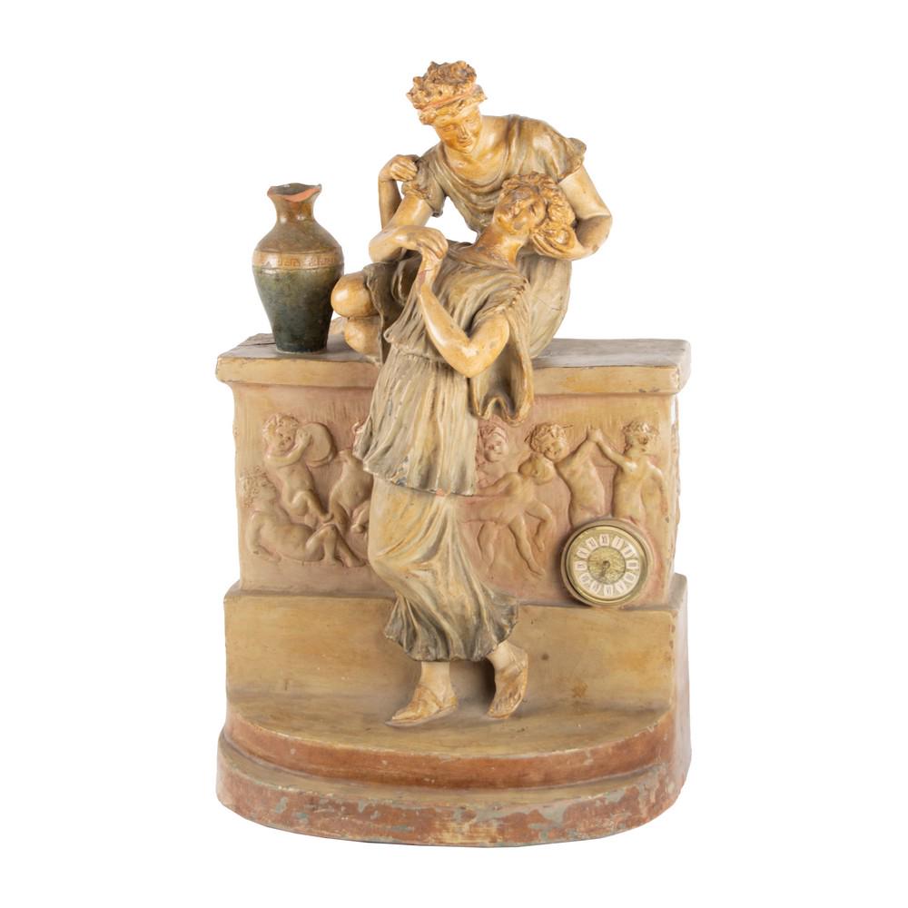 OROLOGIO in terracotta smaltata e lavorata raffigurante: OROLOGIO in terracotta smaltata e lavorata raffigurante "Fanciulli" e "Gioco di putti" (rotture). Meta' '900 Misure: cm 36 x 26 h cm 60