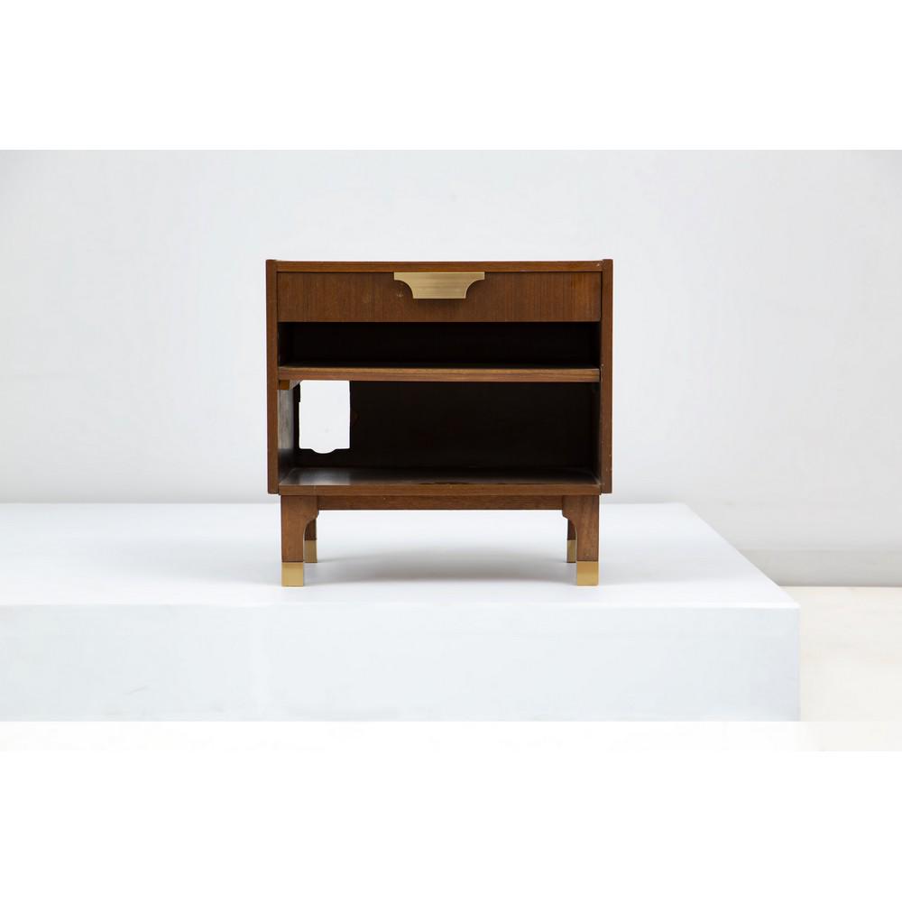 PRODUZIONE ITALIANA 1970 ca. Un comodino: PRODUZIONE ITALIANA 1970 ca. Un comodino in legno di noce, piano rettangolare, un cassetto, un vano a giorno, piedi e maniglia in metallo dorato. cm 56 x 44 Alt, cm 53,5.
