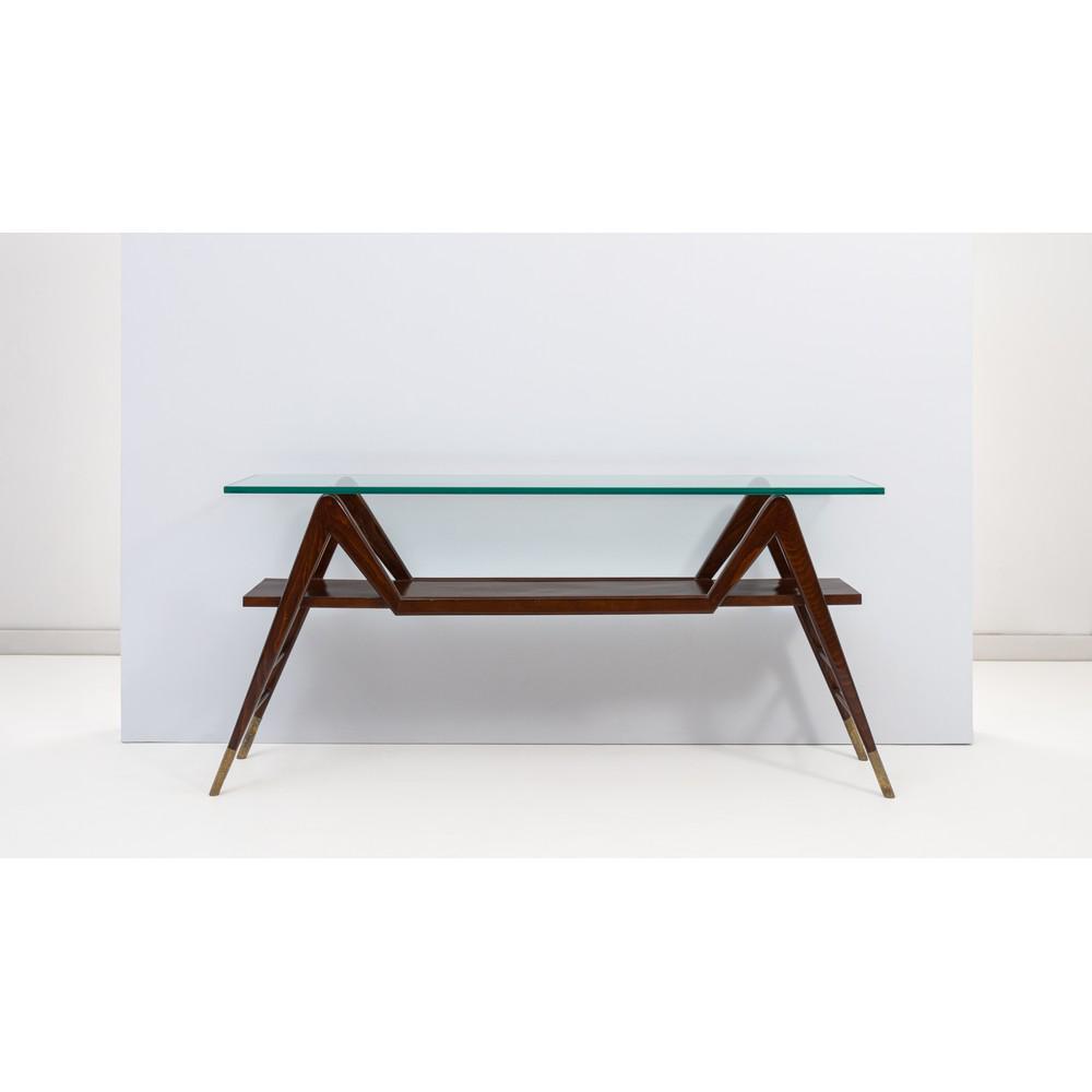 PIERLUIGI GIORDANI, Consolle in legno di mogano: PIERLUIGI GIORDANI Produzione Italia 1950 ca. Consolle in legno di mogano, base zoomorfa in costole di legno curvo che sostengono un ripiano rettangolare, piedi in ottone, ripiano superiore in vetro d
