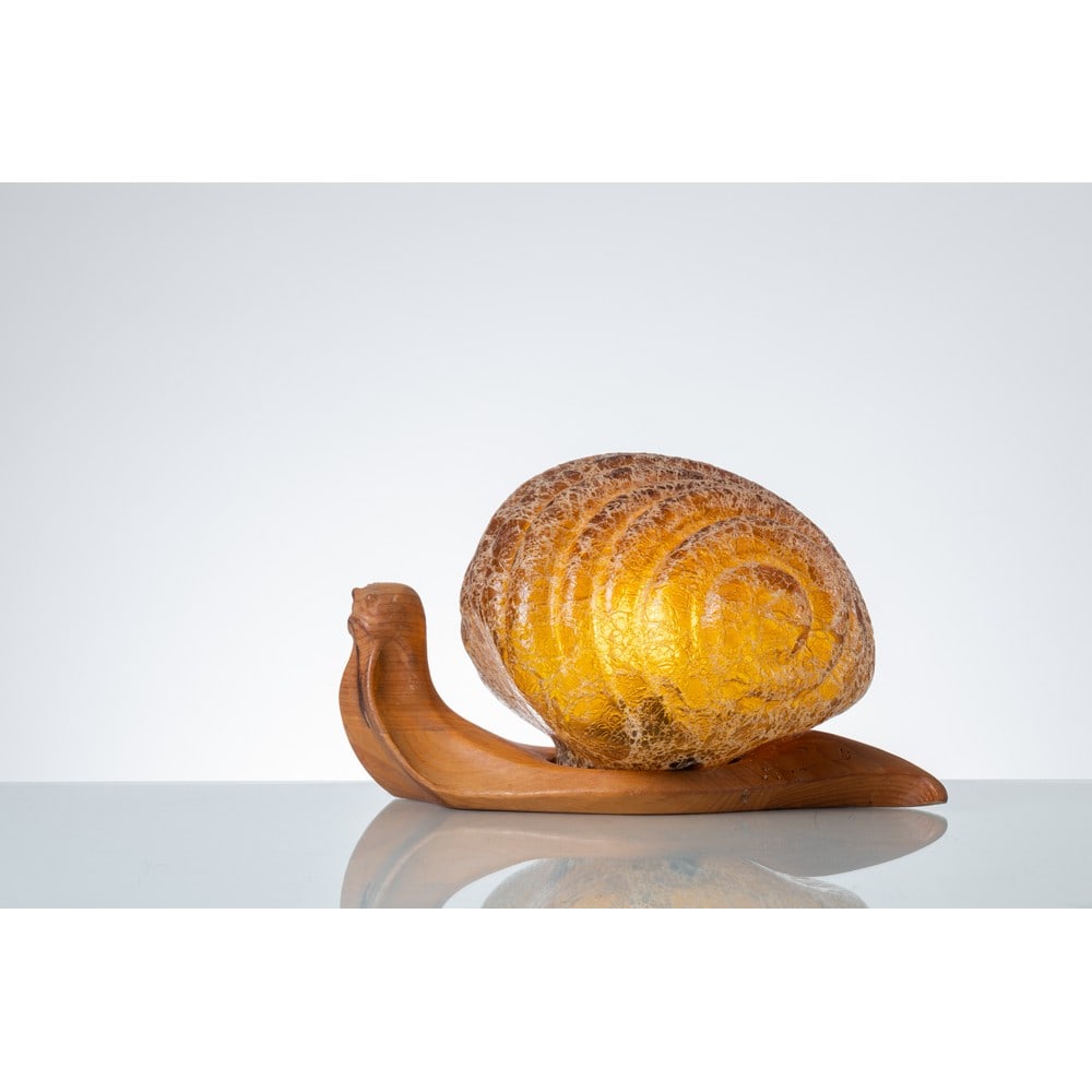 MARZIO CECCHI, Lampada da tavolo “Snail”: MARZIO CECCHI Produzione Studio Most, Italia 1960 ca. Lampada da tavolo “Snail” ad una luce, corpo a lumaca con struttura in legno con diffusore in vetro di murano in vetro ambra con decor