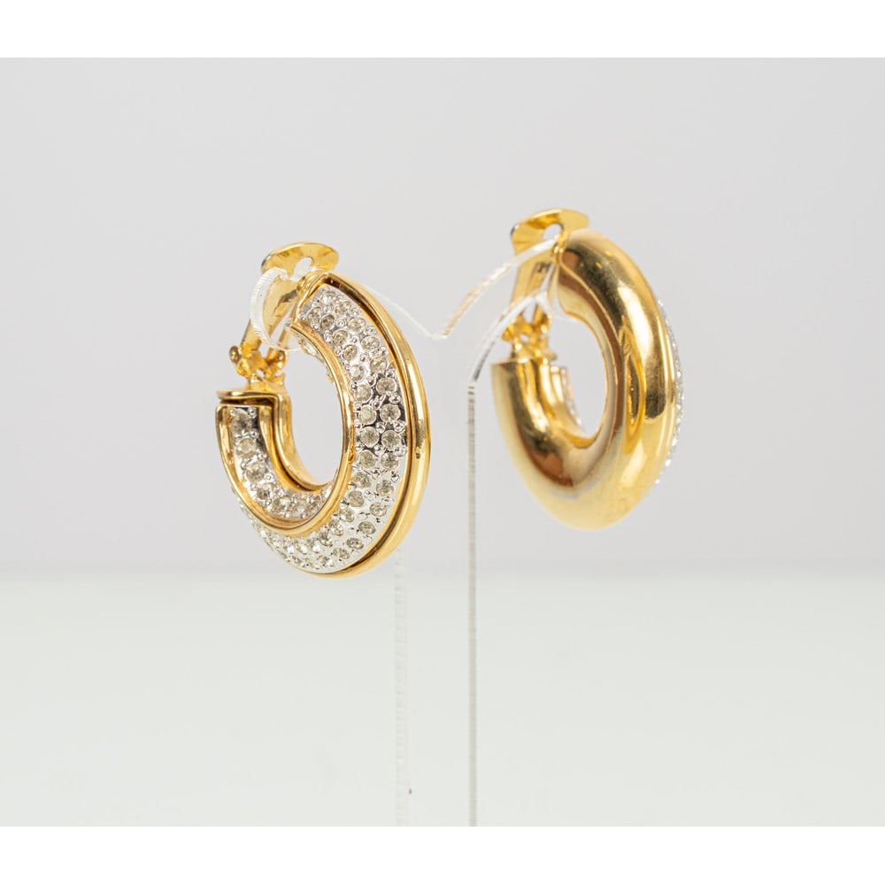 YVES SAINT LAURENT, Orecchini a cerchio: YVES SAINT LAURENT Produzione Francia 1990 ca.Orecchini a cerchio con montatura in metallo placcato oro, diamanti sintetici taglio brillante, chiusura a clips. Marchio di produzione.