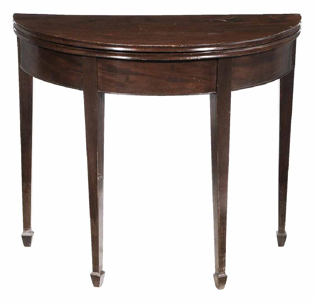 Hepplewhite Mahogany Fold-Over Games: Table British, circa 1800, demilune fold-over top set on tapered legs with spade feet, 29-1/2 x 34-1/2 x 17 in.. Provenance: N/A