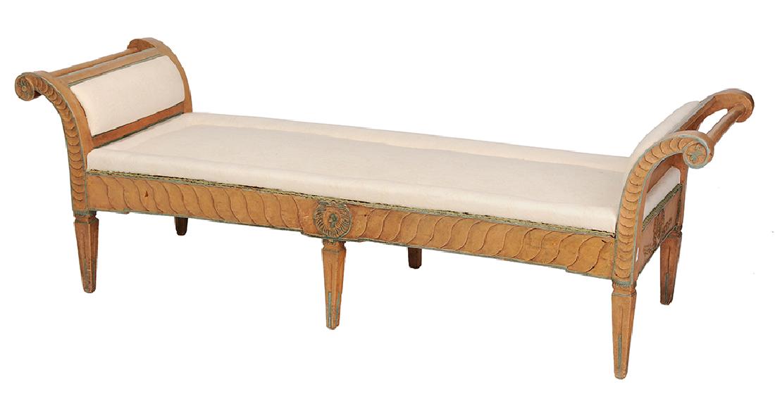 Italian Neoclassical Style Carved and Painted Window: 19th/20th century, chaise or window bench with scrolled arms, quilted upholstery, frame with terracotta paint with prussian blue highlights, pinned construction, 79 in.. Provenance: Property from the 