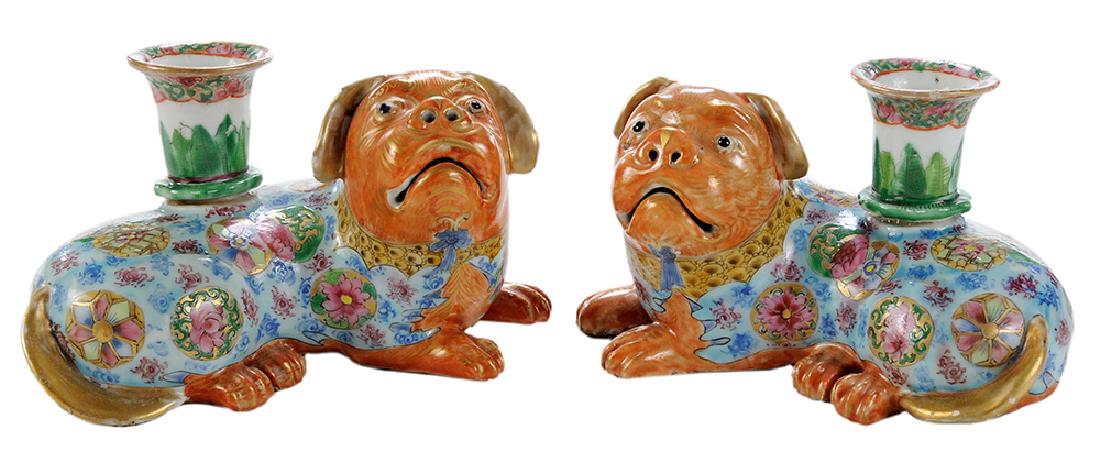 Pair of Chinese Export Porcelain Fu Dog Candlesticks: Chinese, 18th century, each figure reclining with open mouths and nostrils, famille rose bodies, gilt tails with raised nozzles, each carrying old Earle Vandekar of Knightsbridge, New York, labels, 7 