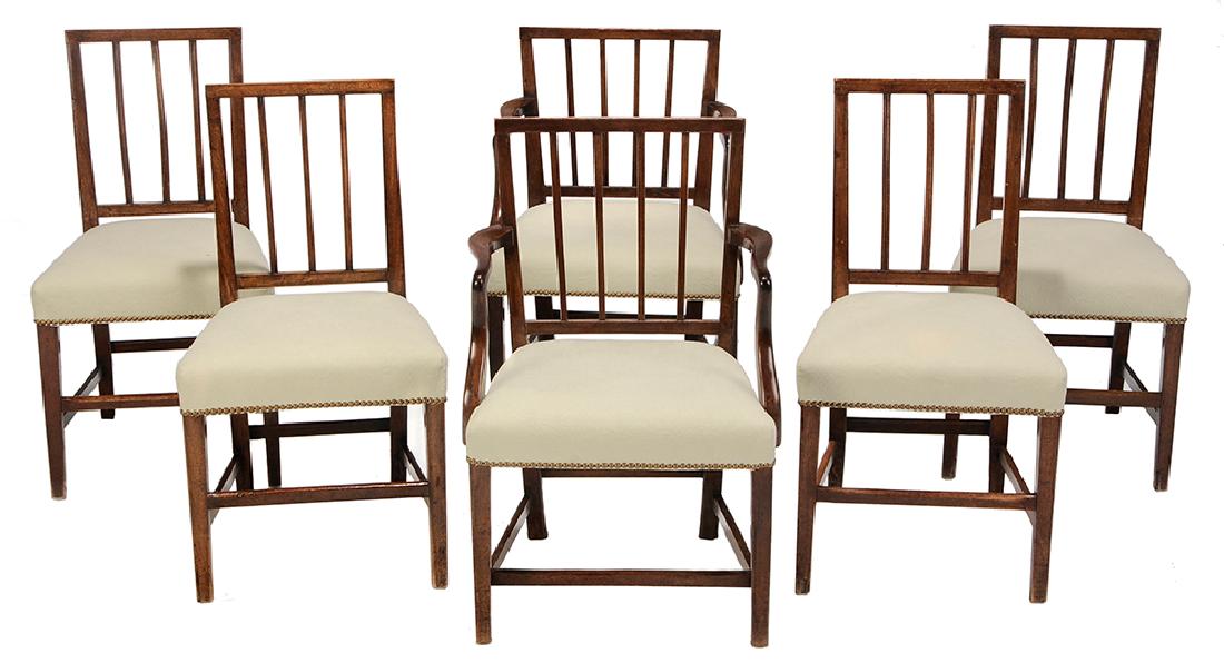Assembled set of Six George III Dining Chairs: British, circa 1800, comprising a pair of arm chairs and a set of four side chairs, mahogany, oak and other mixed woods, all in matching pale green quilted over the rail upholstery with brass tacking,