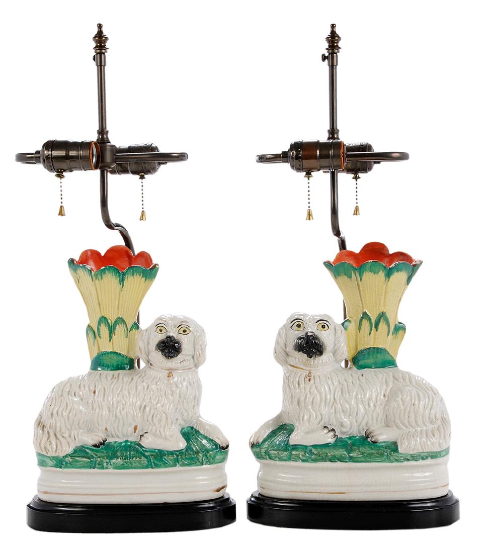 Pair Staffordshire Spaniel Vases Mounted as Lamps: British, late 19th/early 20th century, pair of rare Staffordshire pottery reclining spaniel vases, seated on black oval bases, mounted with two light sockets as lamps, 12 in. to top if vase. Provenanc
