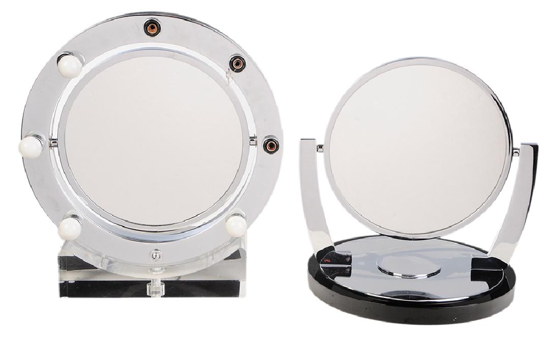 Two Modern Chrome Magnifying Mirrors: American, 20th century, one chrome and lucite base lighted magnifying mirror, 15 in., [good condition]; one chrome and black metal base magnifying mirror, 13-1/2 in., [good condition]. Provenance: Pro