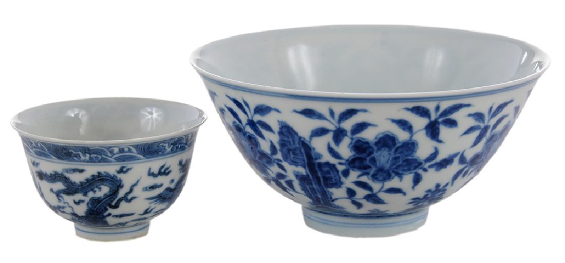 Two Blue and White Porcelain Bowls: Chinese, finely potted rice bowl decorated with peonies,marked with six character Kangxi mark in underglaze blue within two concentric circles, 2-3/4 x 5-3/4 in.; dragon and phoenix decorated tea bowl