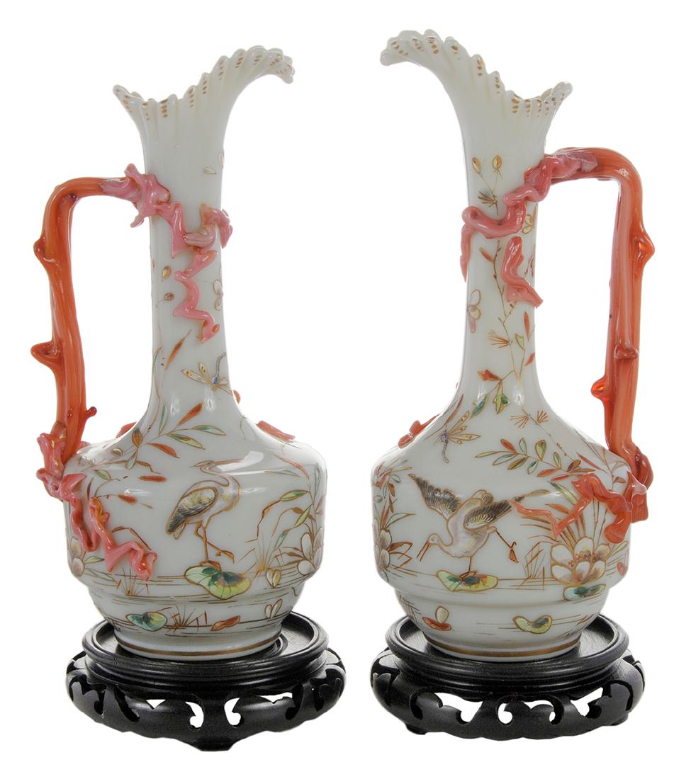 Pair of Glass Ewers With Cranes: English, 19th century, white opaline glass, with applied twig form handles and applied branch elements on body, enamel chinoisserie decoration of cranes, dragonflies among flora and fauna, crimped edg