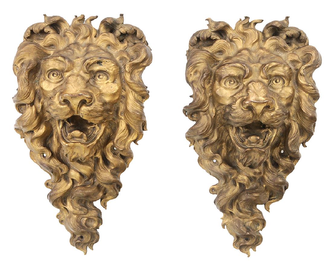 Pair Large Gilt Bronze Bearded Lion-Mask Architectural: probably Continental, late 19th century, finely molded gilt bronze, fierce open-mouthed lion, curly hair and beard, two mounting holes below chin, unsigned, 16-1/2 x 9 in.. Provenance: A Tennessee Col