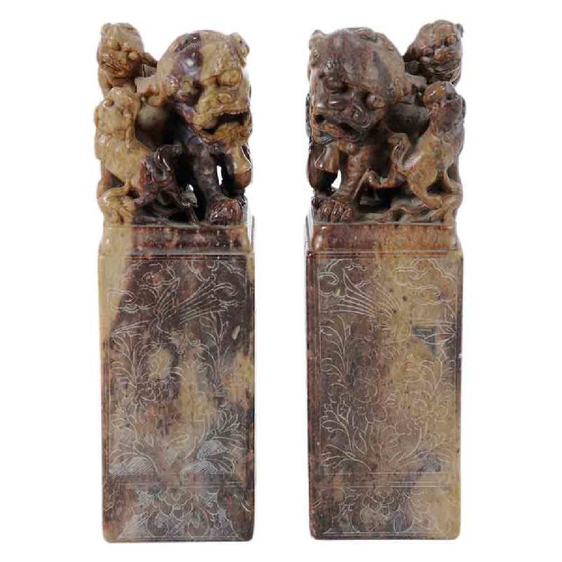 Pair Carved Soapstone Foo Lion Chop Seals: Chinese, 20th century, each with Buddhist lion and pup terminals, all sides engraved with flowers and vines, 7 in. Â Â