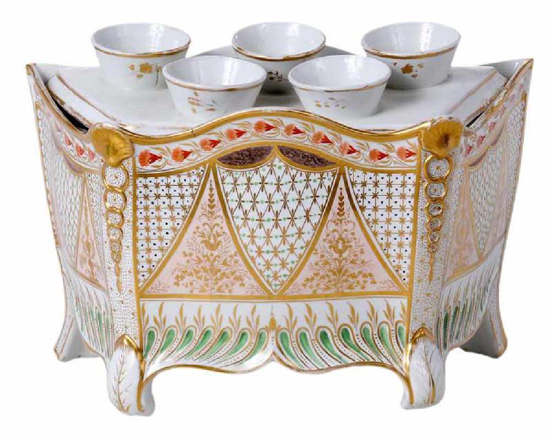 Empire Porcelain Bough Pot: French, early 19th century, fashioned after a bombay chest, white ground with gilt panels with sections of pink swags, molded gilt scallop shell panels, borders highlighted with green and orange, cur