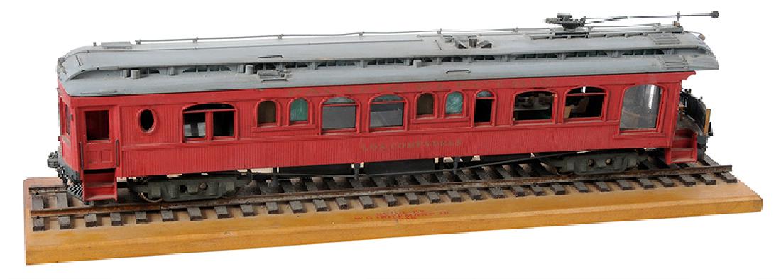 Handcrafted Train Car Model: American, 1948, hand crafted model of a train car on track, mounted on a board, painted red, with grey roof, interior train furniture, reads "Pacific Electric/Los Compadres", "Built by WG Hoffman Jr