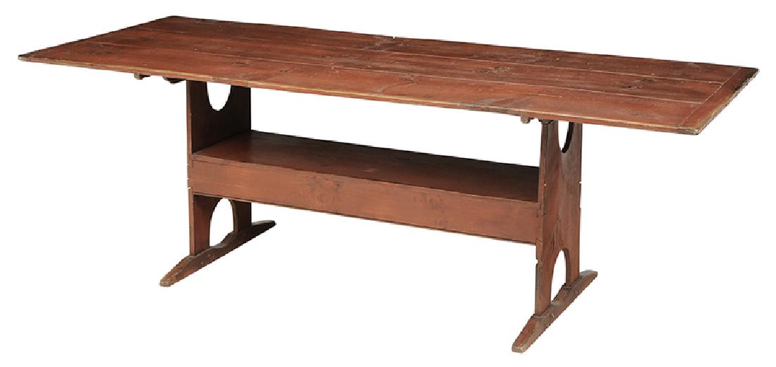 American Country Red-Painted Hutch Table: 20th century, red painted pine with removable tilting top with breadboard ends over bench form base with sled feet, pinned and through tenon construction, 29 x 84 x 34 in.