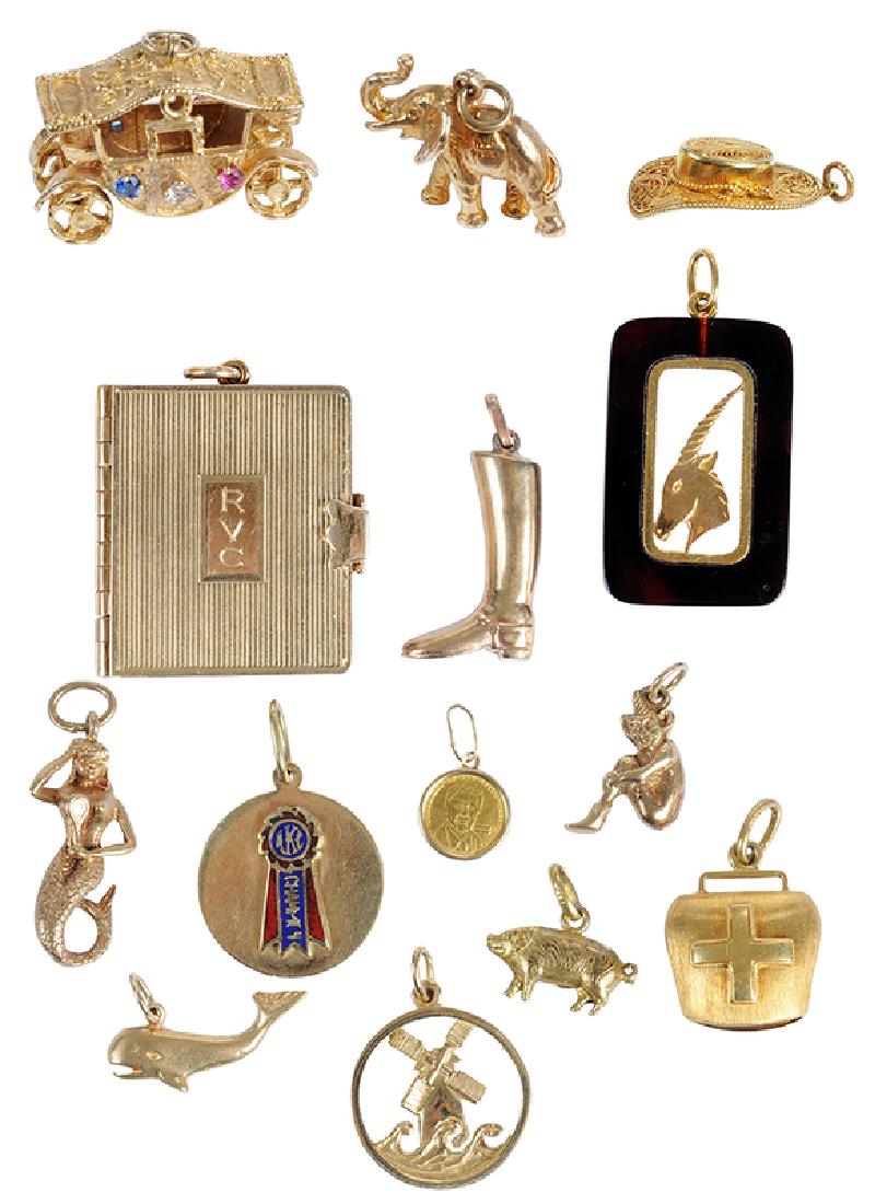 14 Gold Charms Including Cartier: three 18kt. charms: bell, hat, antelope, one 18kt. yellow gold chain 23-1/2 in. lg., 15.5 grams; seven 14kt. charms: one photo book stamped "Cartier, 14K", pig, whale, windmill, mermaid, AKC charm,