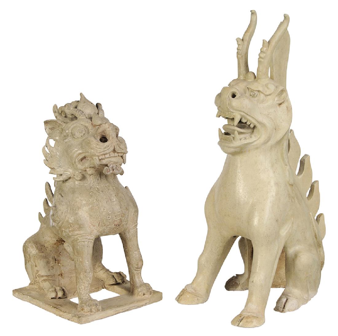Two Sui Dynasty Straw Glazed Spirit Animals: Chinese, possibly 7th century, lion form seated on a pierced base, large head with flaring nostrils, spiky mane with horns, molded breast plate and armor plates on shoulders, spiky elements on spine, 