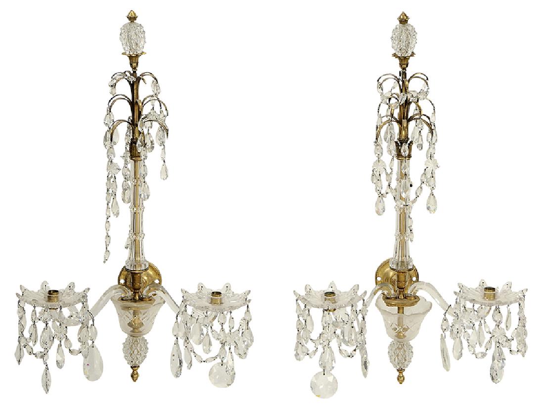 Pair Louis XVI Style Bronze and Crystal Sconces: French, 19th century, each with crystal clad columns supporting leafy capital strung with crystal drops, each with two swing arms supporting diamond pattern candle cups and bobeches with hanging hangi