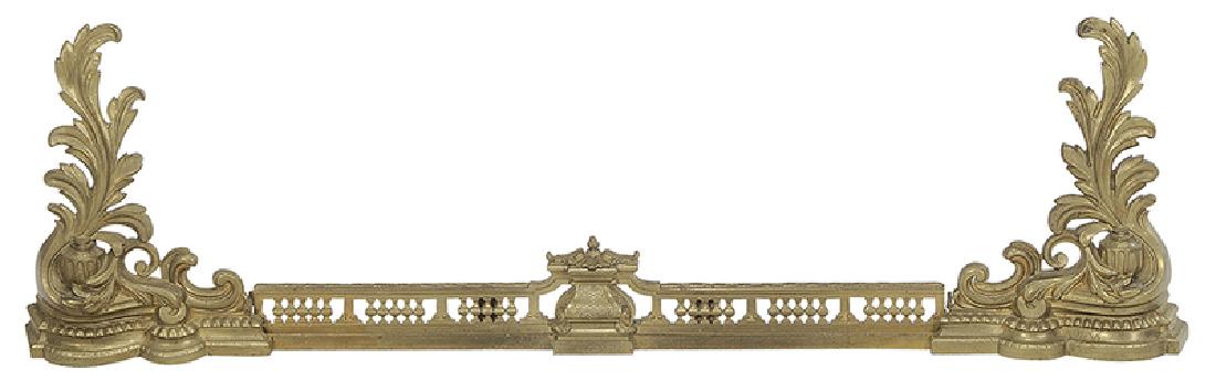 Set of Louis XV Style Gilt Bronze Chenets: French, late 19th/early 20th century, each with leaf decorated andiron, 17-3/4 in.; centering pierced fender, 38 in.