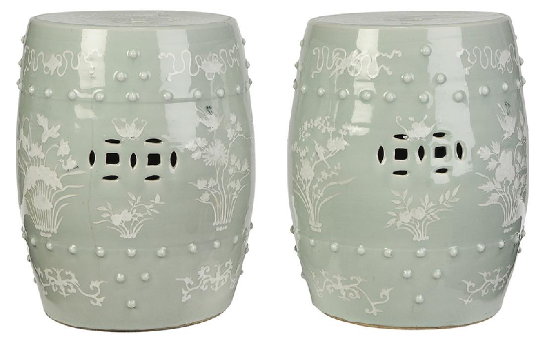 Pair Chinese Celadon Porcelain Garden Seats: Chinese, probably late Qing dynasty, white slip decoration of flowers, birds and bats on celadon ground, pierced sides, 18-1/2 in. Note: Consignor purchased in Europe circa 1967 and had them shipped t