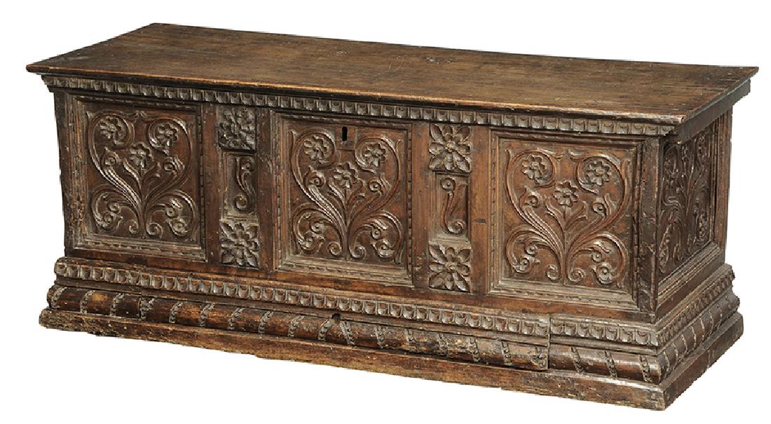 Baroque Carved Walnut Lift Top Coffer: Continental, probably 18th century, hinged lid with iron strap hinges and open interior, dovetailed paneled case with leaf and rosette carved decoration, carved and molded base, fitted with single lon